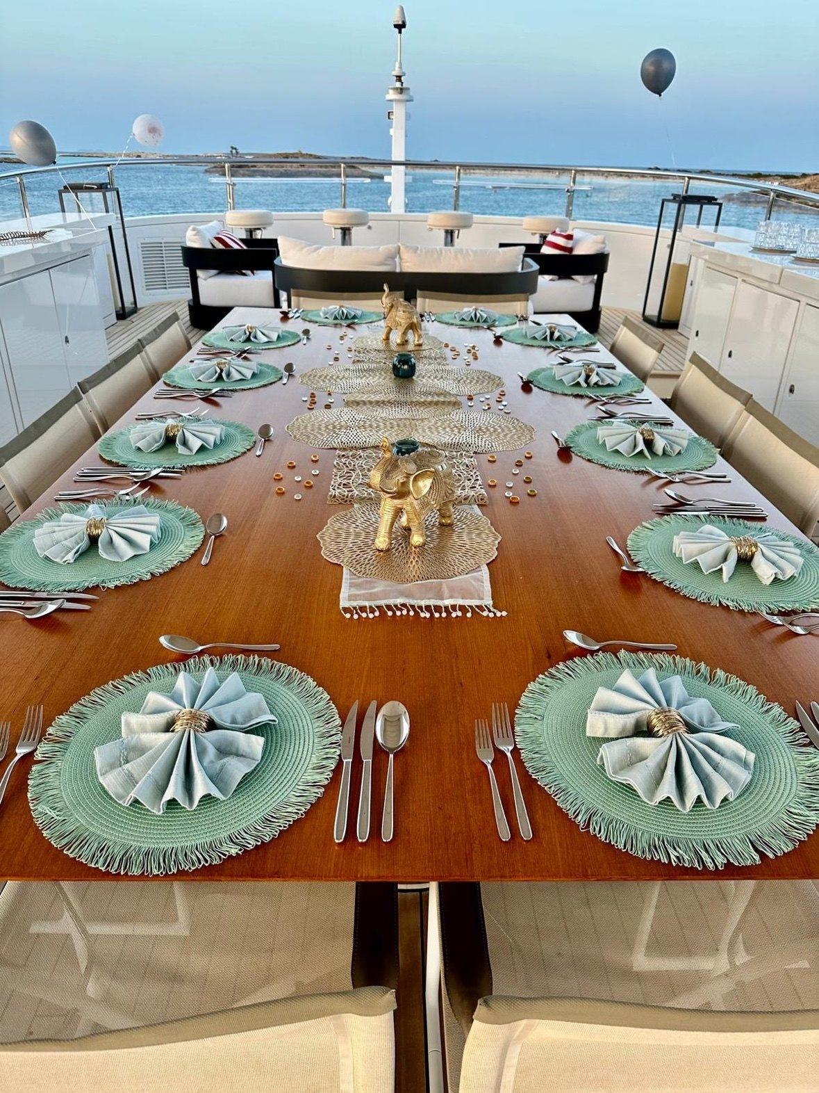 Aft deck tablescape with teal place settings