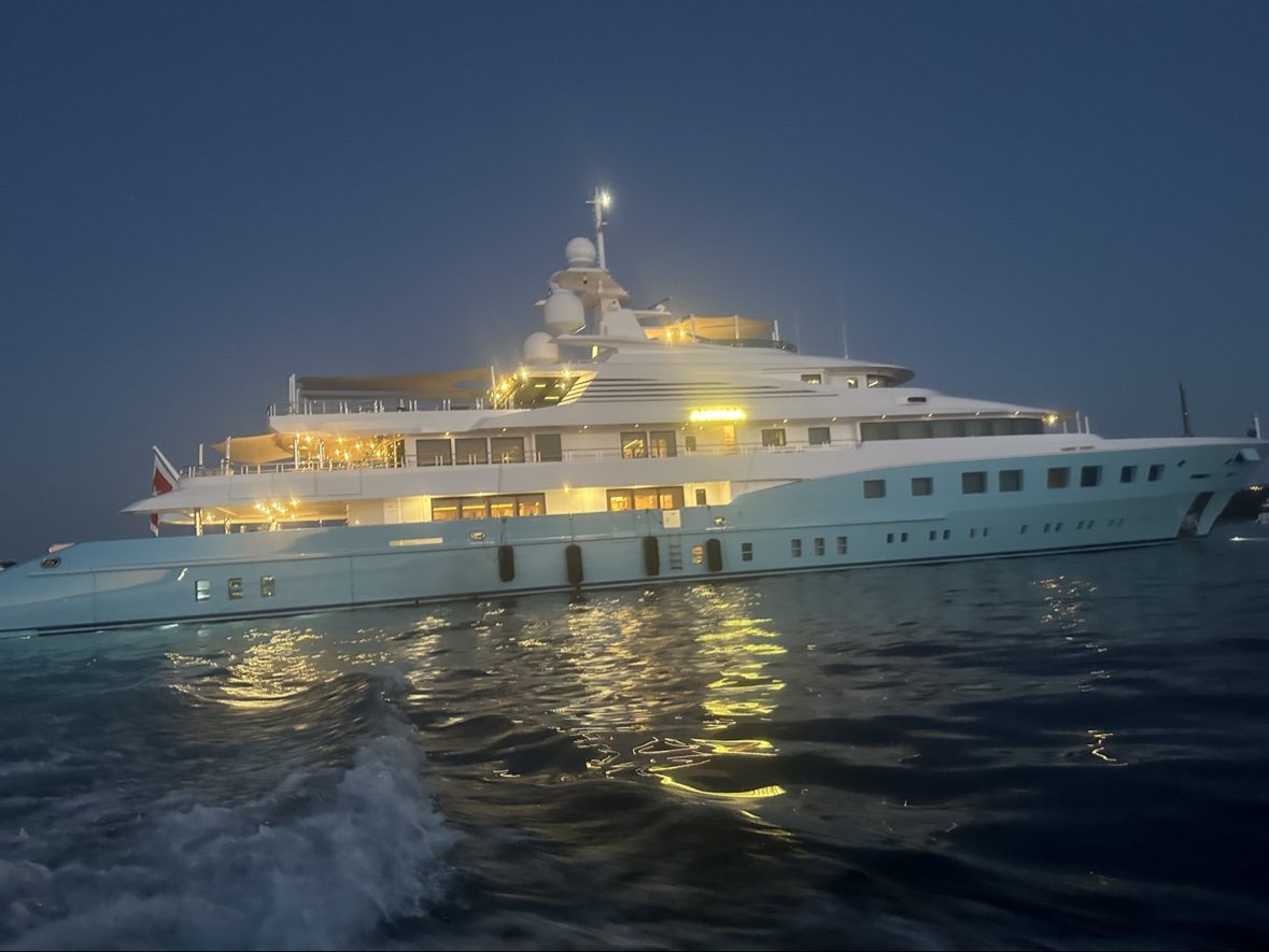 Motor yacht lit up at dusk